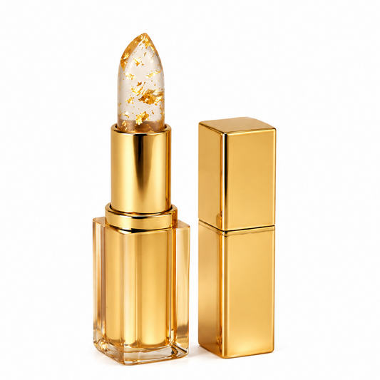 Een luxe gouden lipstick met een transparante balsem en fijne gouddeeltjes, in een elegante, glanzende verpakking.